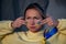 War portrait of Ukrainian woman with national flag on cheek crying