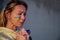 War portrait of Ukrainian woman with national flag on cheek crying