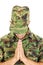 War soldier praying in military camouflage uniform with head bow