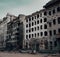 War-Torn Urban Landscape: Bullet-Ridden Facades and Damaged Buildings (AI Generated)