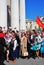 War veterans sing war songs. Soviet army red flag waves above people.