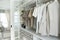 Wardrobe with shirts and pants hanging