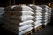 In the warehouse, chemical fertilizer sacks stand by for their vital journey