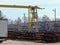 Warehouse and distribution of metal products under the open sky. Loading rail crane and car in the warehouse. Metallurgical branch