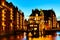 The Warehouse district Speicherstadt during twilight sunset in Hamburg, Germany. Illuminated warehouses in Hafencity quarter in