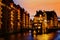 The Warehouse district Speicherstadt during twilight sunset in Hamburg, Germany. Illuminated warehouses in Hafencity quarter in