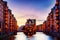 The Warehouse district Speicherstadt during twilight sunset in Hamburg, Germany. Illuminated warehouses in Hafencity quarter in