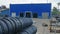 Warehouse of finished plastic pipes industrial outdoors storage site. Manufacture of plastic water pipes factory.