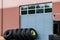 Warehouse industrial building windowed garage door with tires