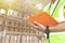 Warehouse inventory management. Warehouse worker holding clipboard his inspecting the products on tall shelves warehouse storage