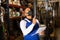 Warehouse male worker in protective mask and overalls counts the quantity of goods and writes in notebook