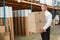 Warehouse manager carrying cardboard boxes