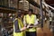 Warehouse manager talking with woman using barcode reader