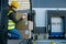 Warehouse receiver kneeling inside of truck in cargo area, trailer, barcode scanning delivered items. Receiving clerk
