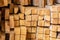 Warehouse stack of lumber dried light beige pine boards floor bars square end pattern building materials eco traditional europe