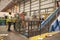 Warehouse staff with a roll cage of cardboard for recycling