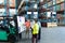 Warehouse staffs discussing over whiteboard in warehouse