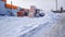 Warehouse store in the open air in winter in the city. Sacks with cement and putty on a wooden pallet, for opening on