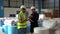 Warehouse Supervisor Talking with Order Builder. Foreman and Manager Working on stock items in the industry. managers workers in w