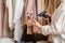 A warehouse woman employee accepts clothes using barcode scanner reading a bar code from price tag of female blouse