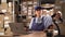 Warehouse woman worker with barcode scanner sitting at the table with laptop computer