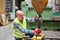 Warehouse worker attaches load to crane hook in warehouse