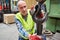 Warehouse worker attaches a load to an iron crane hook