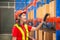 Warehouse worker with bar code scanner checking inventory, Female worker scanning boxes in warehouse rack, Workers working in