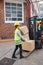 Warehouse worker brings packages to the forklift