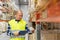 Warehouse worker with clipboard and plastic box