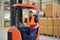 warehouse worker in a forwarding agency - interior with forklift - transport and storage of goods