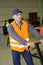 Warehouse worker in high-vis vest pushing pallet truck