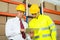 Warehouse Worker And Manager Looking At Laptop