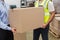 Warehouse worker and manager passing a box