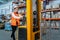 Warehouse worker operates a pallet loader.