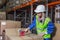 Warehouse worker packing boxes in storehouse