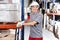 Warehouse Worker Pushing Handtruck With Cardboard