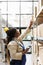 Warehouse worker reaching for parcel at cardboard boxes shelf