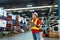 Warehouse Worker in safety suite working with tablet computer to record data the stock inventory in large warehouses, a Smart