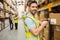 Warehouse worker scanning box while smiling at camera