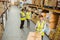 Warehouse worker sealing cardboard boxes for shipping