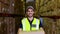 Warehouse worker smiling at camera carrying a box