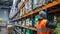 Warehouse worker stocking shelves with fresh produce