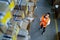 Warehouse worker with touchpad looking at shelves with boxes.