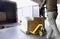 Warehouse worker unloading cargo shipment goods, his using hand pallet jack load into a truck.