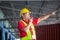 Warehouse worker working in factory warehouse industry and using radio talking communication, Foreman in hardhat safety vest with