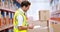 Warehouse worker writing on clipboard