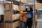 Warehouse workers choosing box to prepare order for shipment