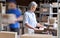 Warehouse workers hurry in blur motion to deliver parcels. Fast delivery concept