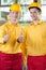 Warehouse workers showing thumbs up sign